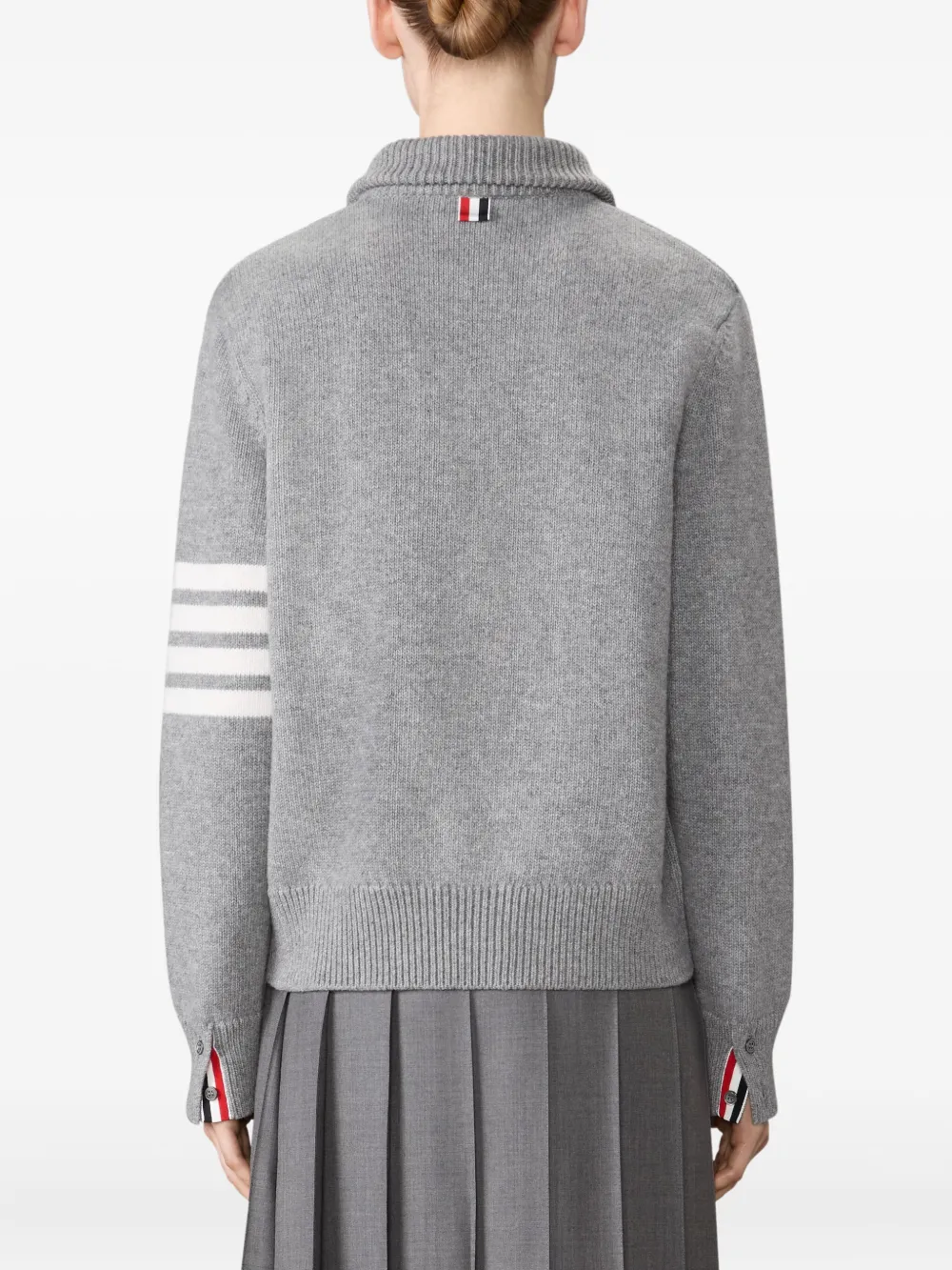 grey knitwear worn by a person, showing the knitwear fit