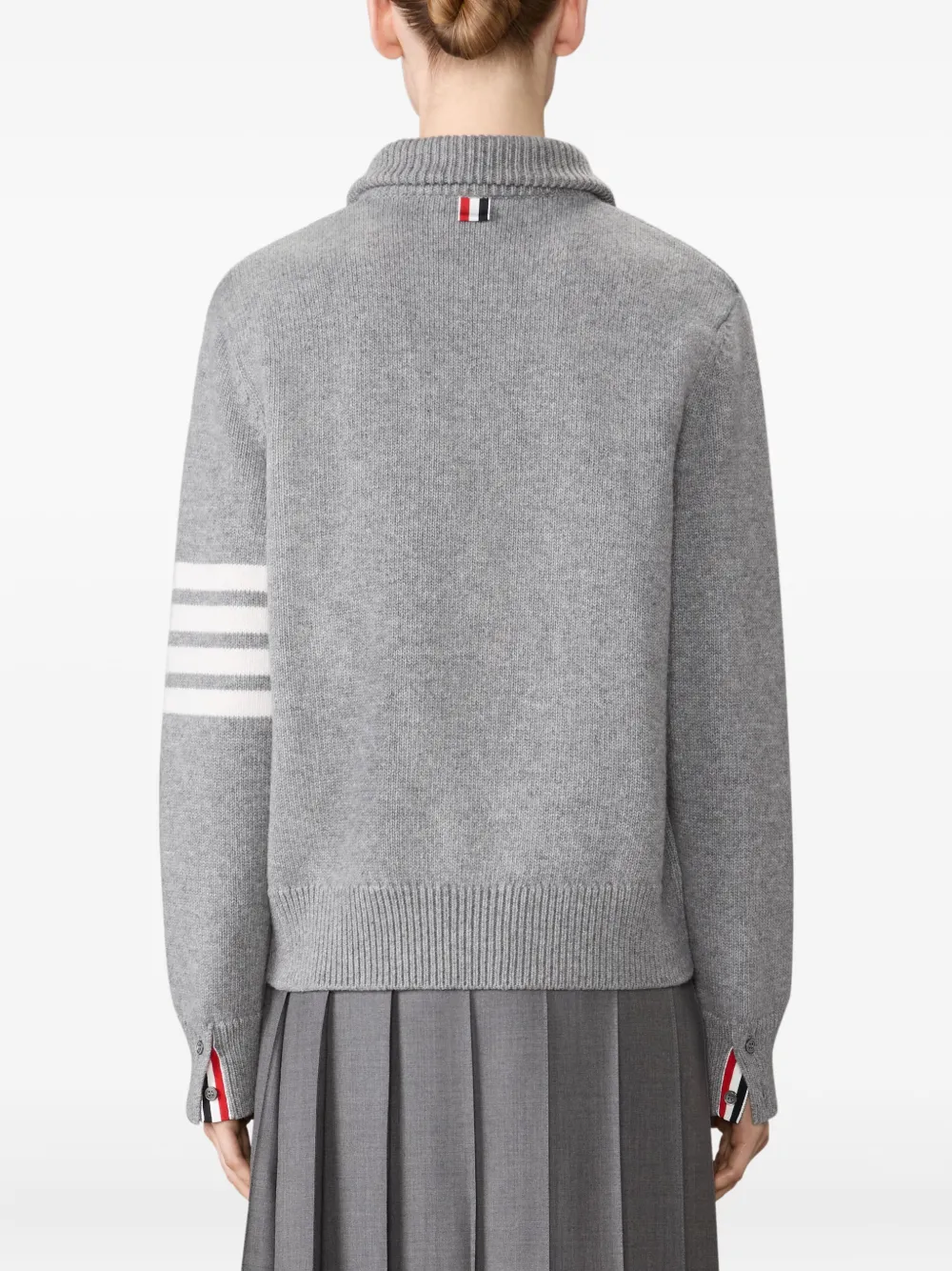 grey knitwear worn by a person, showing the knitwear fit