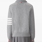 grey knitwear worn by a person, showing the knitwear fit