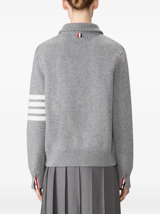 grey knitwear worn by a person, showing the knitwear fit