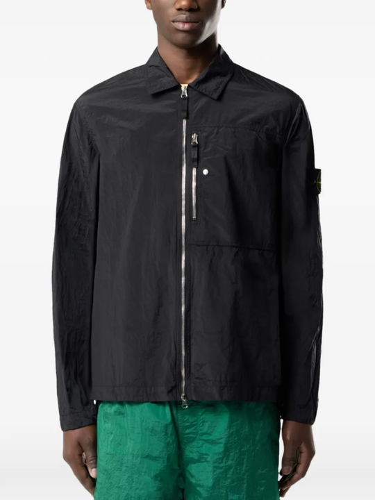 Black jacket worn by a person, showing the black jacket's fit