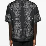 Black shirt worn by a person, showing the shirt fi