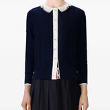 Navy knitwear worn by a person, showing the knitwear's fit