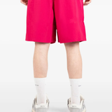 Pink shorts worn by a person, showing the shorts fit