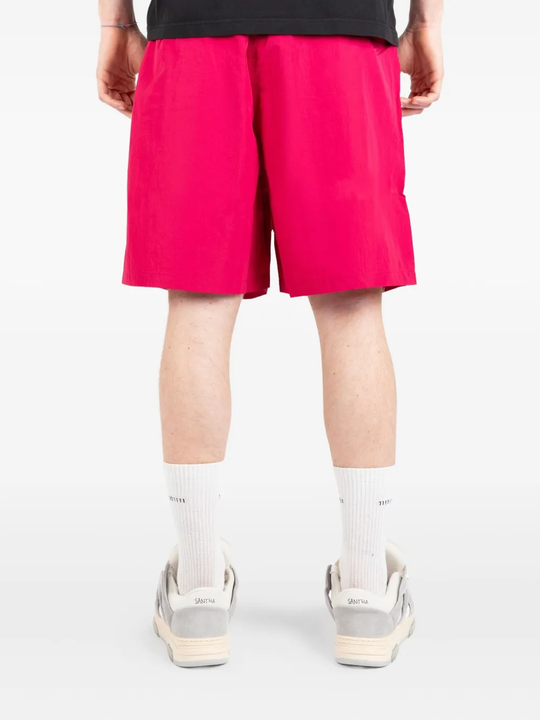 Pink shorts worn by a person, showing the shorts fit