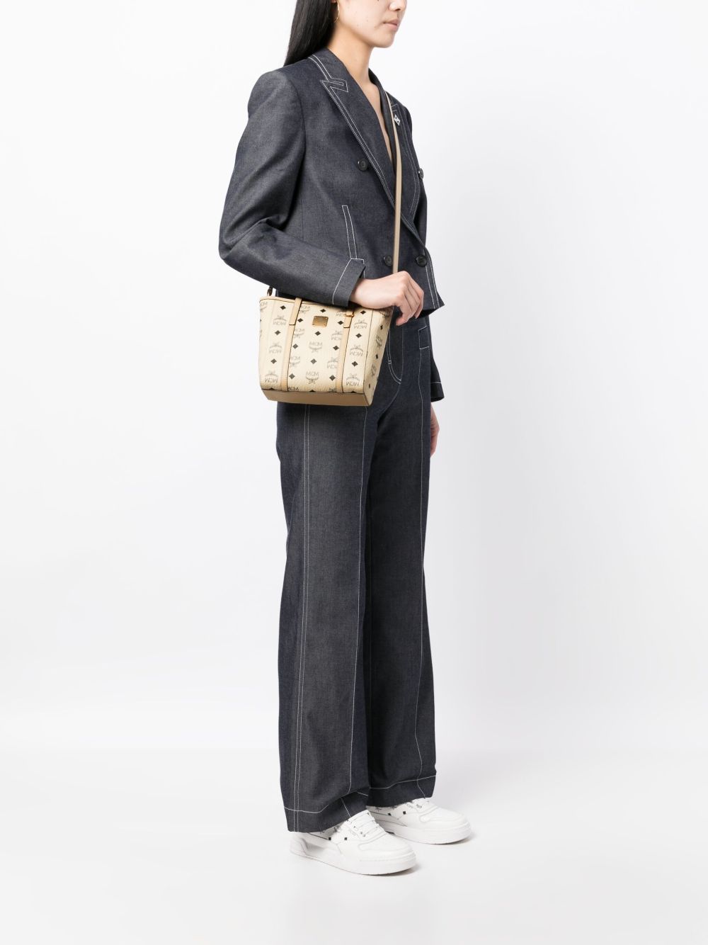 Tan bag carried by a person, showing the bag's fit