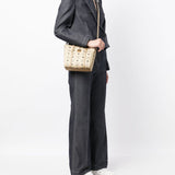 Tan bag carried by a person, showing the bag's fit