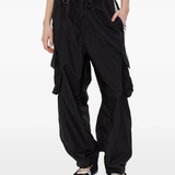 black pants worn by a person, showing the pants fit