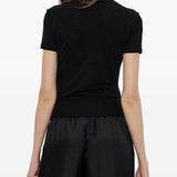 Black top worn by a person, showing the top's fit