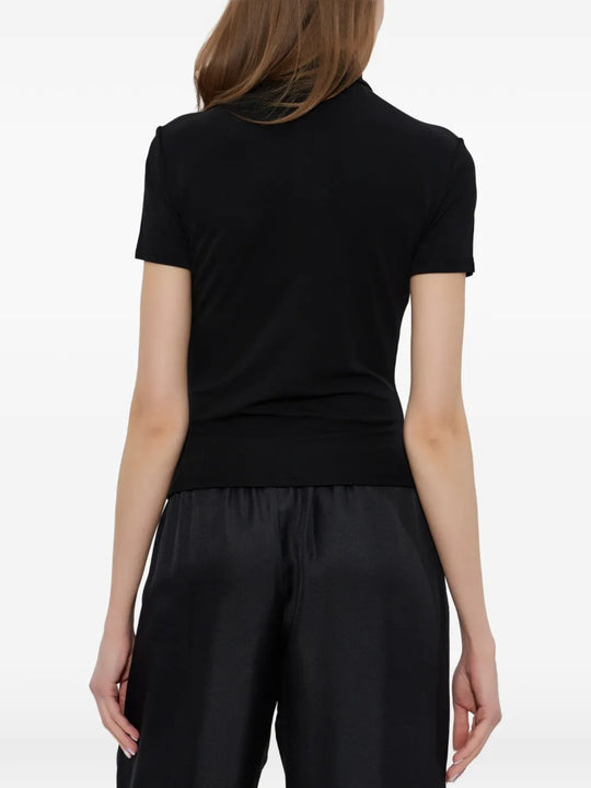 Black top worn by a person, showing the top's fit