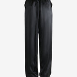 Black pants worn by a person, showing the pants' fit