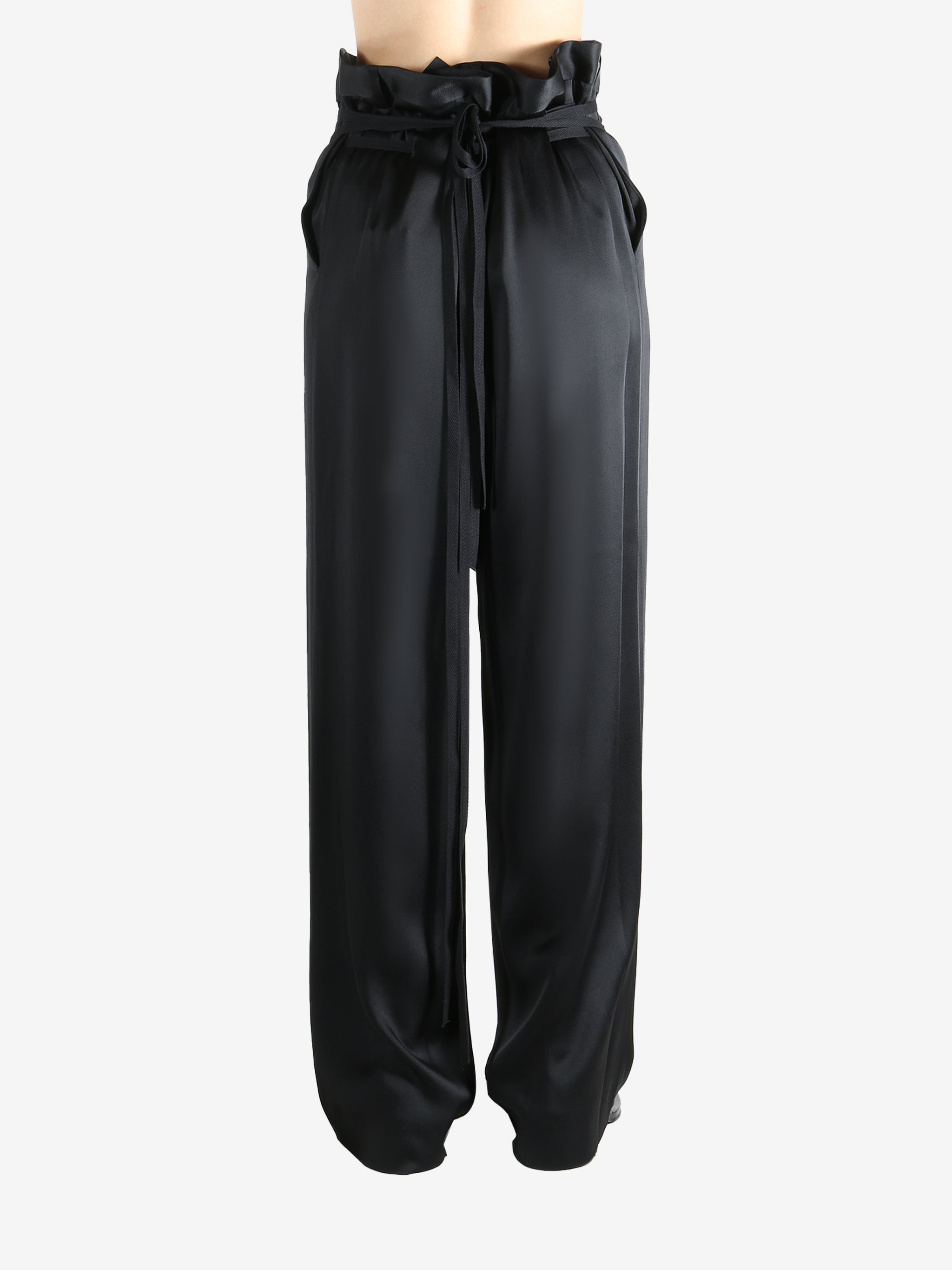 Black pants worn by a person, showing the pants' fit