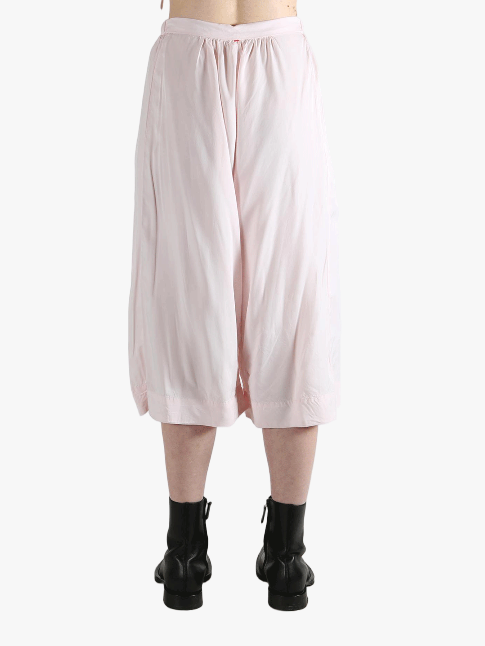 Pink pants worn by a person, showing the pants fit