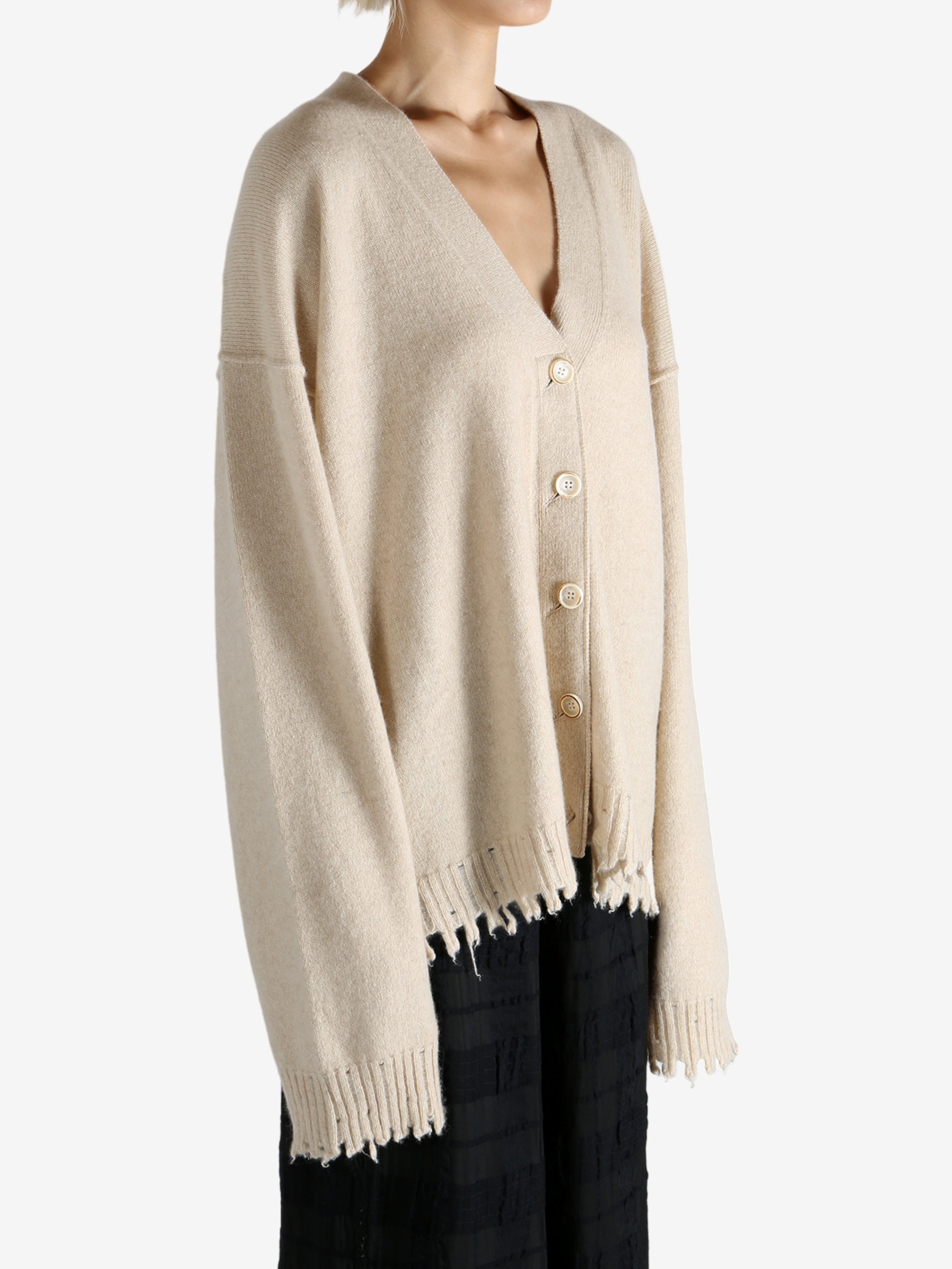 Tan knitwear worn by a person, showing the knitwear fit