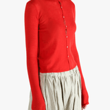 Red knitwear worn by a person, showing the knitwear's fit