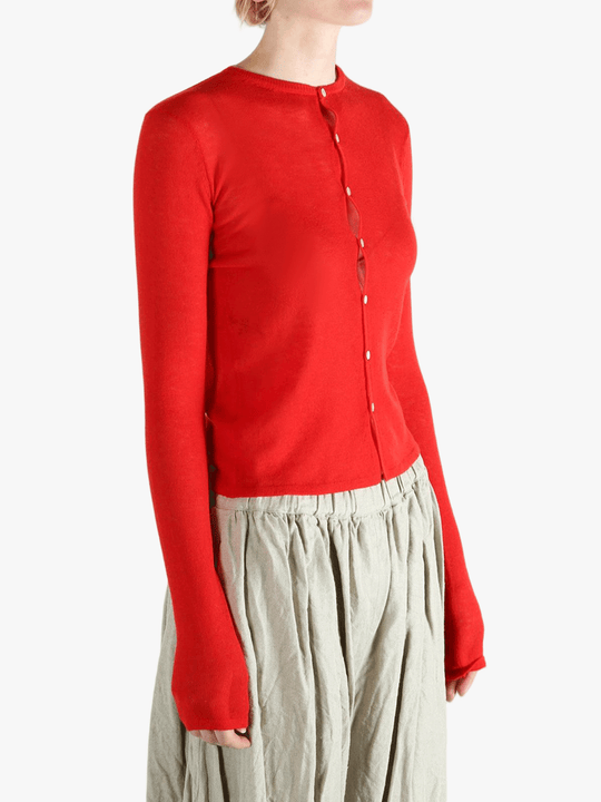 Red knitwear worn by a person, showing the knitwear's fit
