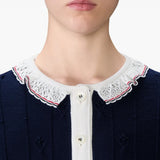 Close up of the navy knitwear, showing texture of the wool fabric