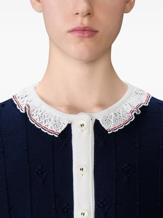 Close up of the navy knitwear, showing texture of the wool fabric