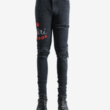 Black jeans worn by a person, showing the jeans fit