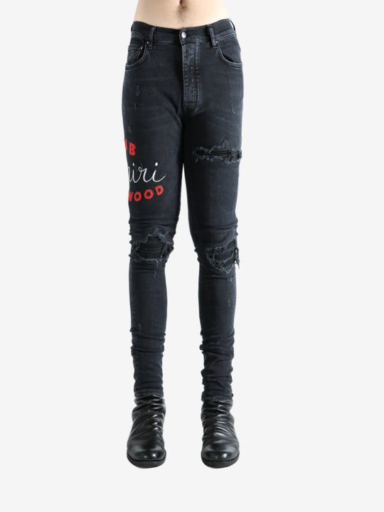 Black jeans worn by a person, showing the jeans fit