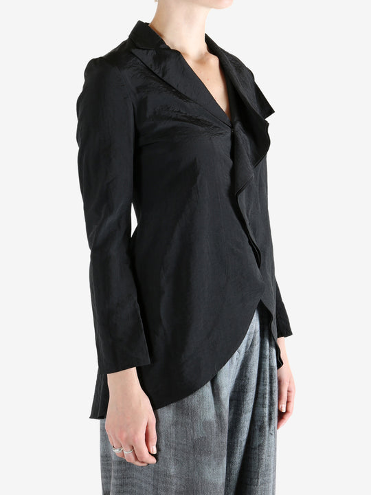 Black jacket worn by a person, showing the jacket's fit