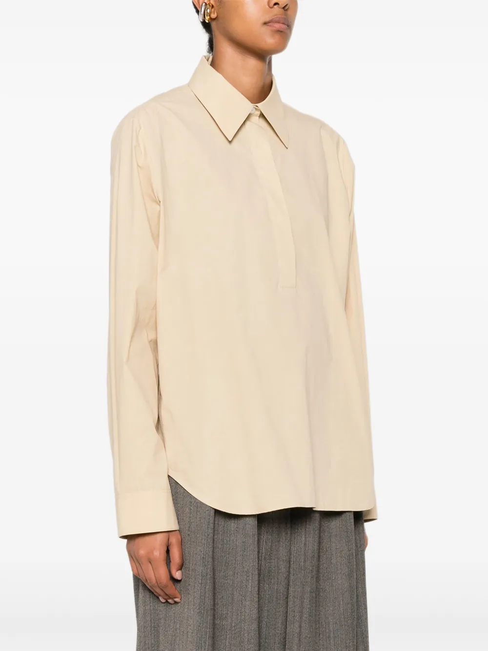 Tan shirt worn by a person, showing the shirt fit