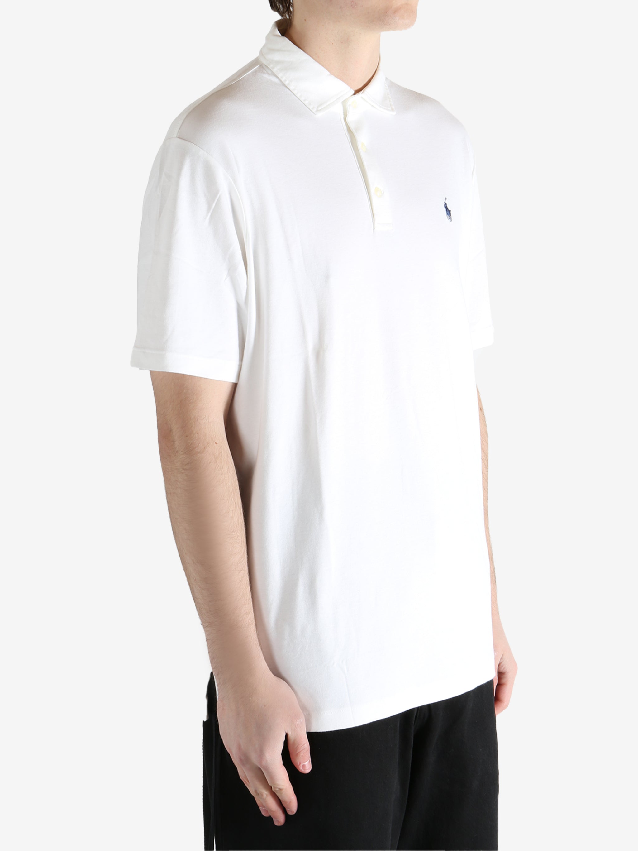 White t-shirt worn by a person, showing the shirt's fit