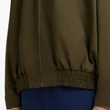 Close up of brown jacket, showing texture of the cotton blend fabric