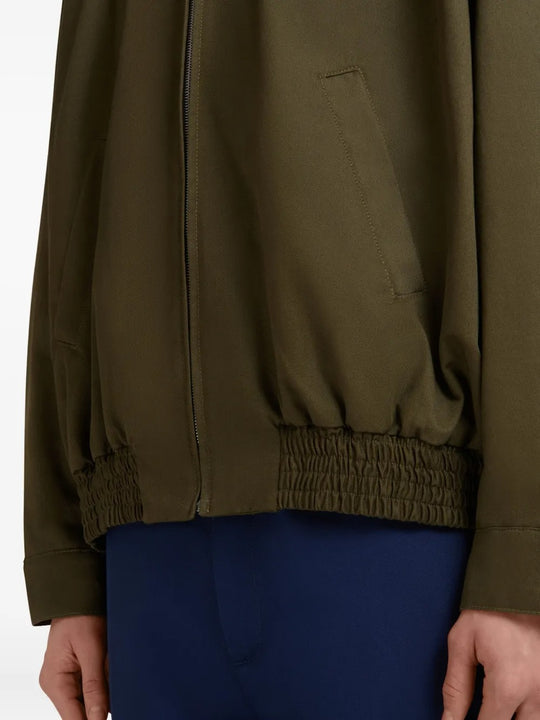 Close up of brown jacket, showing texture of the cotton blend fabric