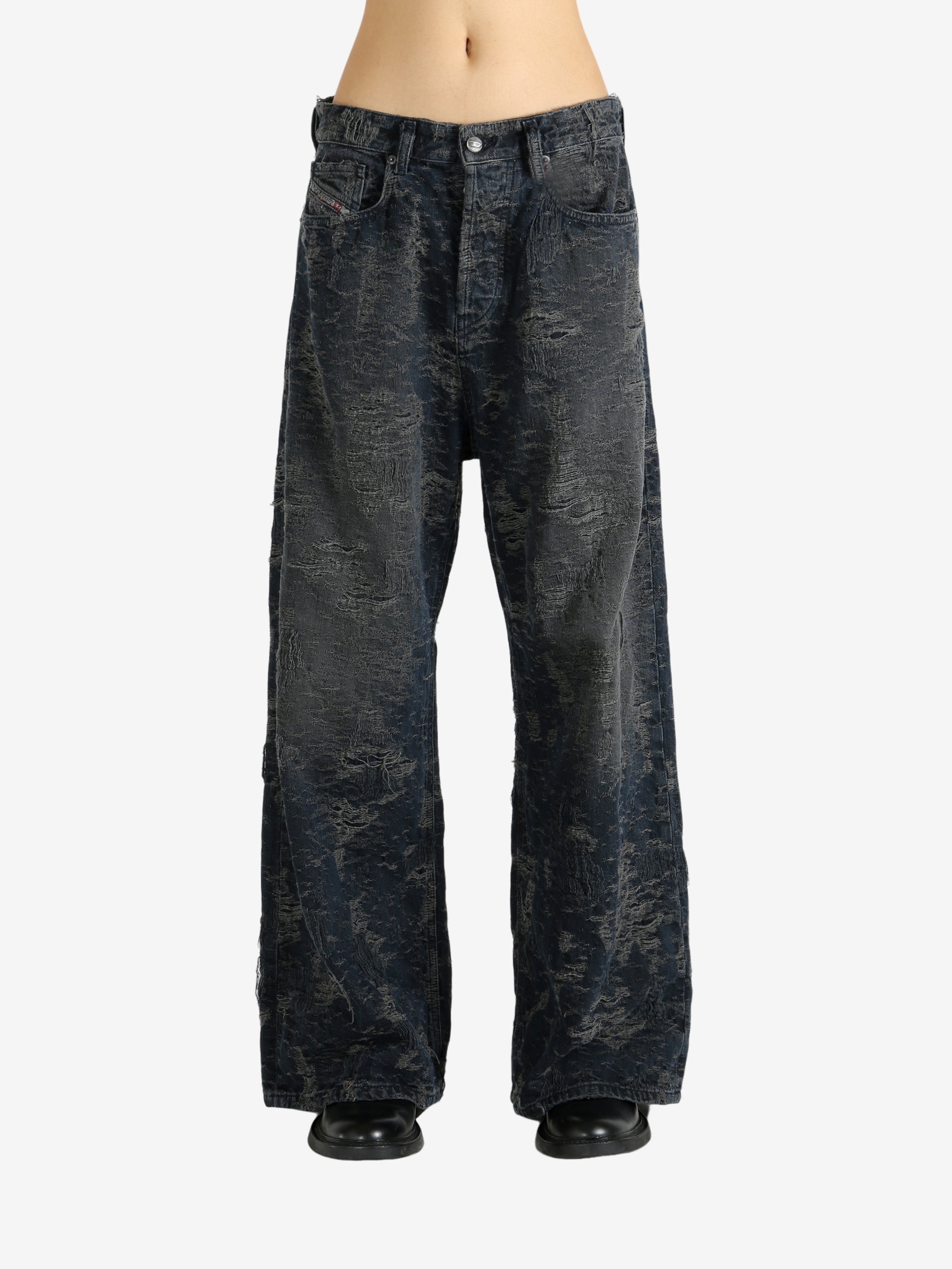 Black jeans worn by a person, showing the jeans' fit