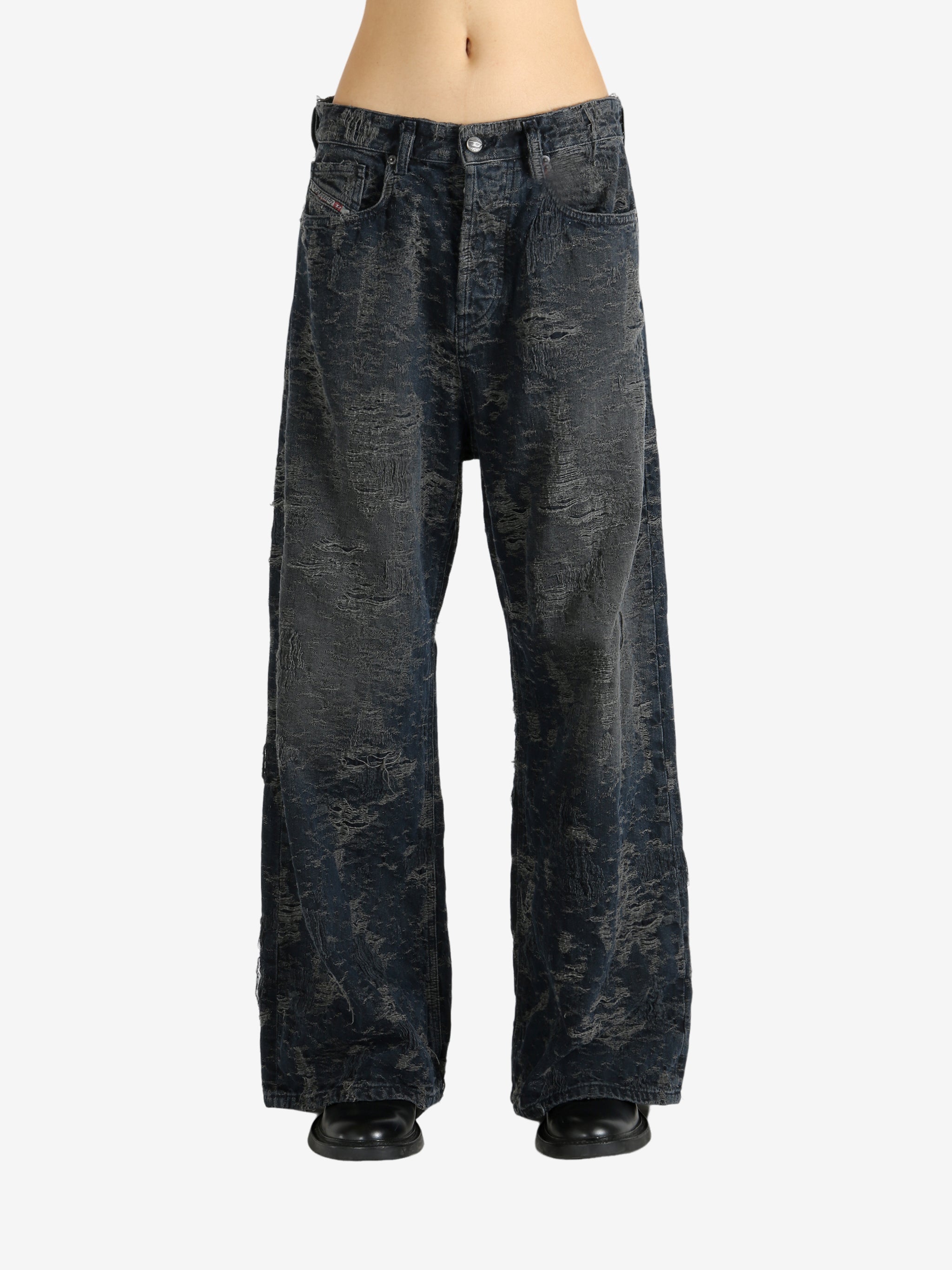 Black jeans worn by a person, showing the jeans' fit