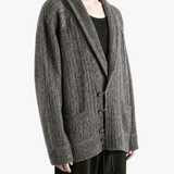 Grey knitwear worn by a person, showing the knitwear fit