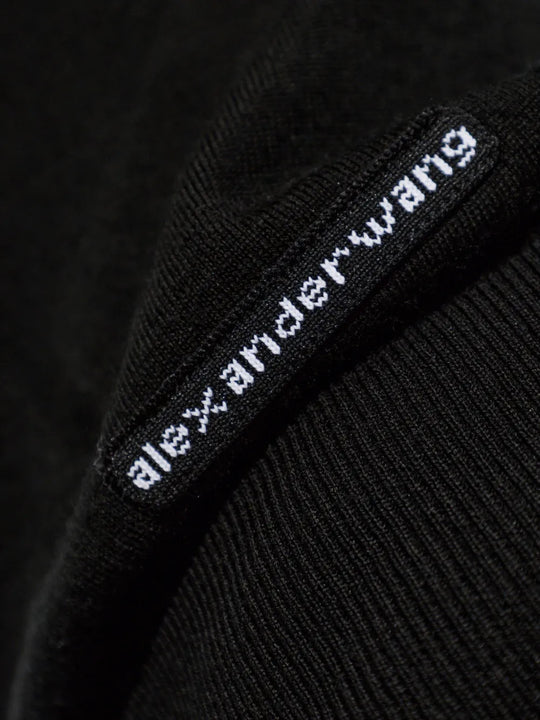 Close up of Black knitwear, showing texture of the 100% wool fabric