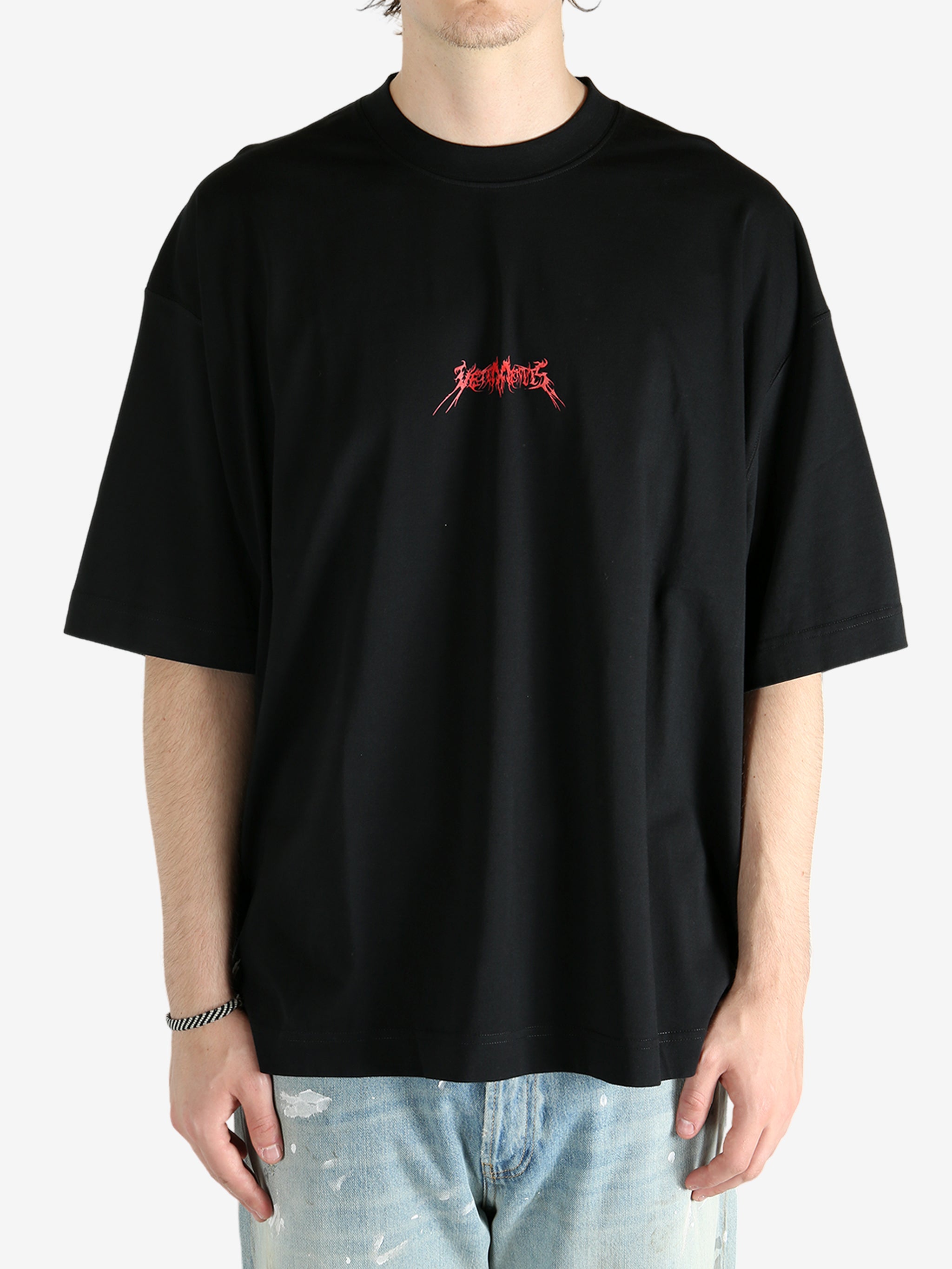 Black t-shirt worn by a person, showing the shirt's fit