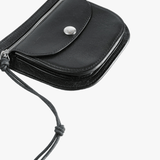 Close up of black small accessories, showing texture of the bull leather fabric