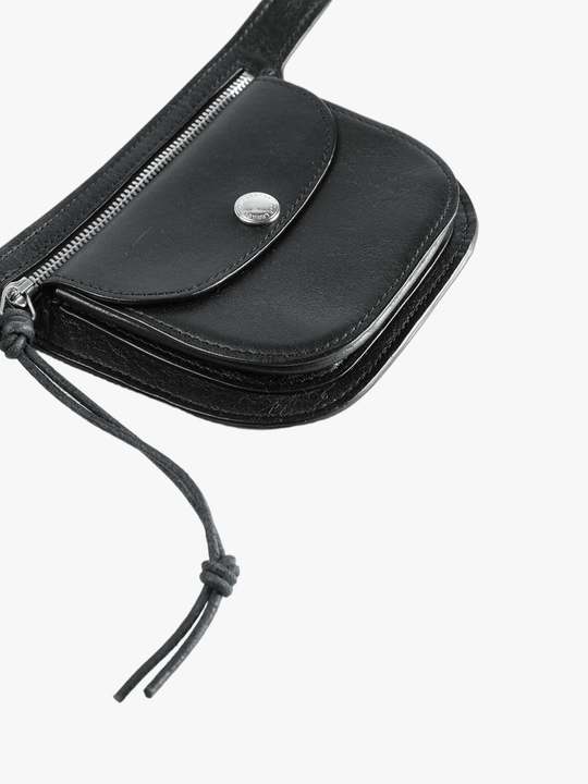 Close up of black small accessories, showing texture of the bull leather fabric