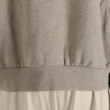 Close up of the brown top, showing texture of the cotton fabric