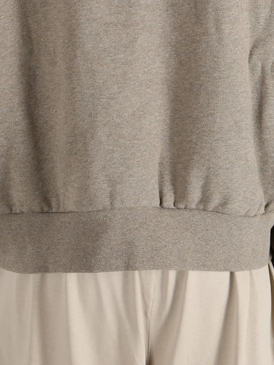 Close up of the brown top, showing texture of the cotton fabric