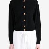 Black knitwear worn by a person, showing the knitwear fit