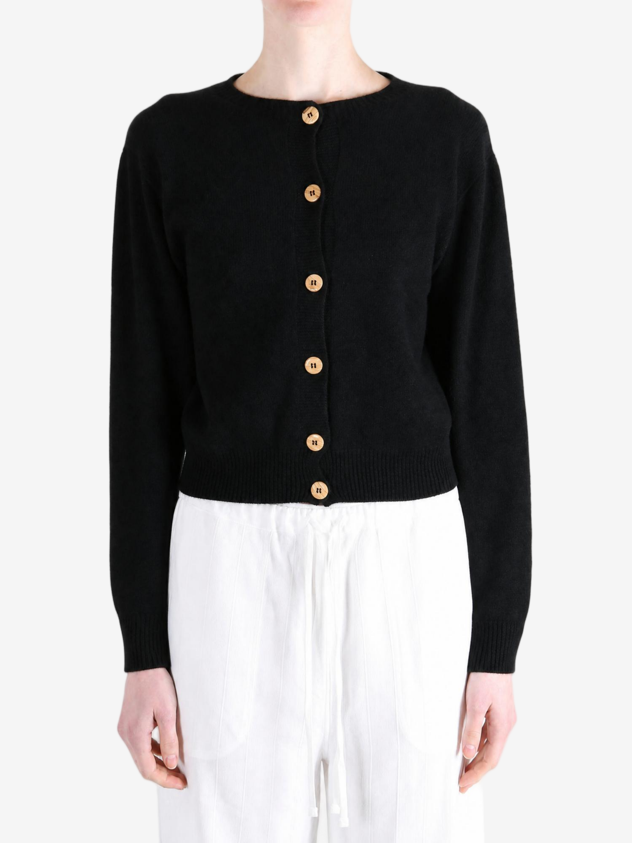 Black knitwear worn by a person, showing the knitwear fit