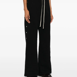 Black pants worn by a person, showing the pants fit