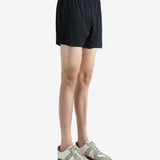Black shorts worn by a person, showing the shorts' fit