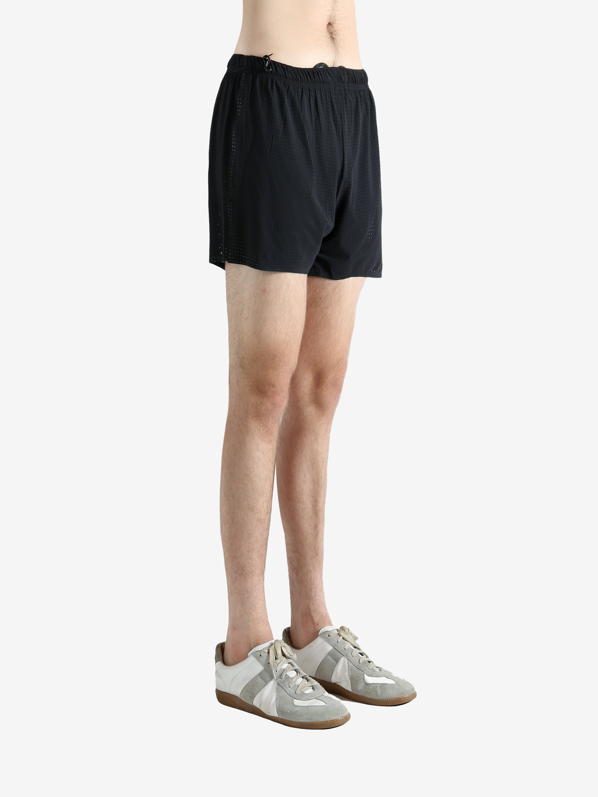 Black shorts worn by a person, showing the shorts' fit