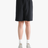 Black short worn by a person, showing the short's fit