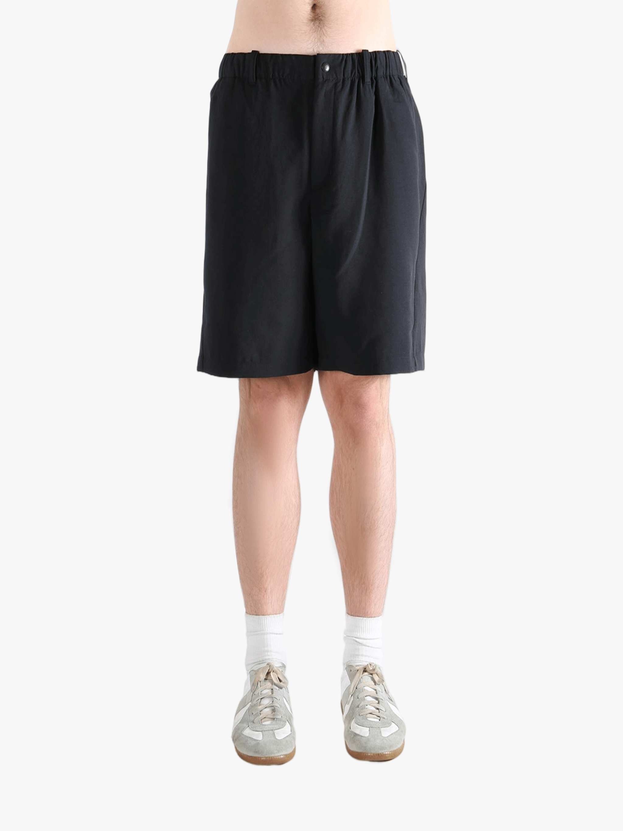Black short worn by a person, showing the short's fit