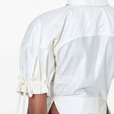 White top worn by a person, showing the top fit