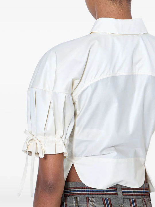 White top worn by a person, showing the top fit