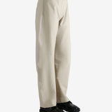 White pants worn by a person, showing the pants' fit