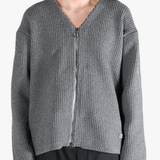 Grey sweater worn by a person, showing the sweater fit