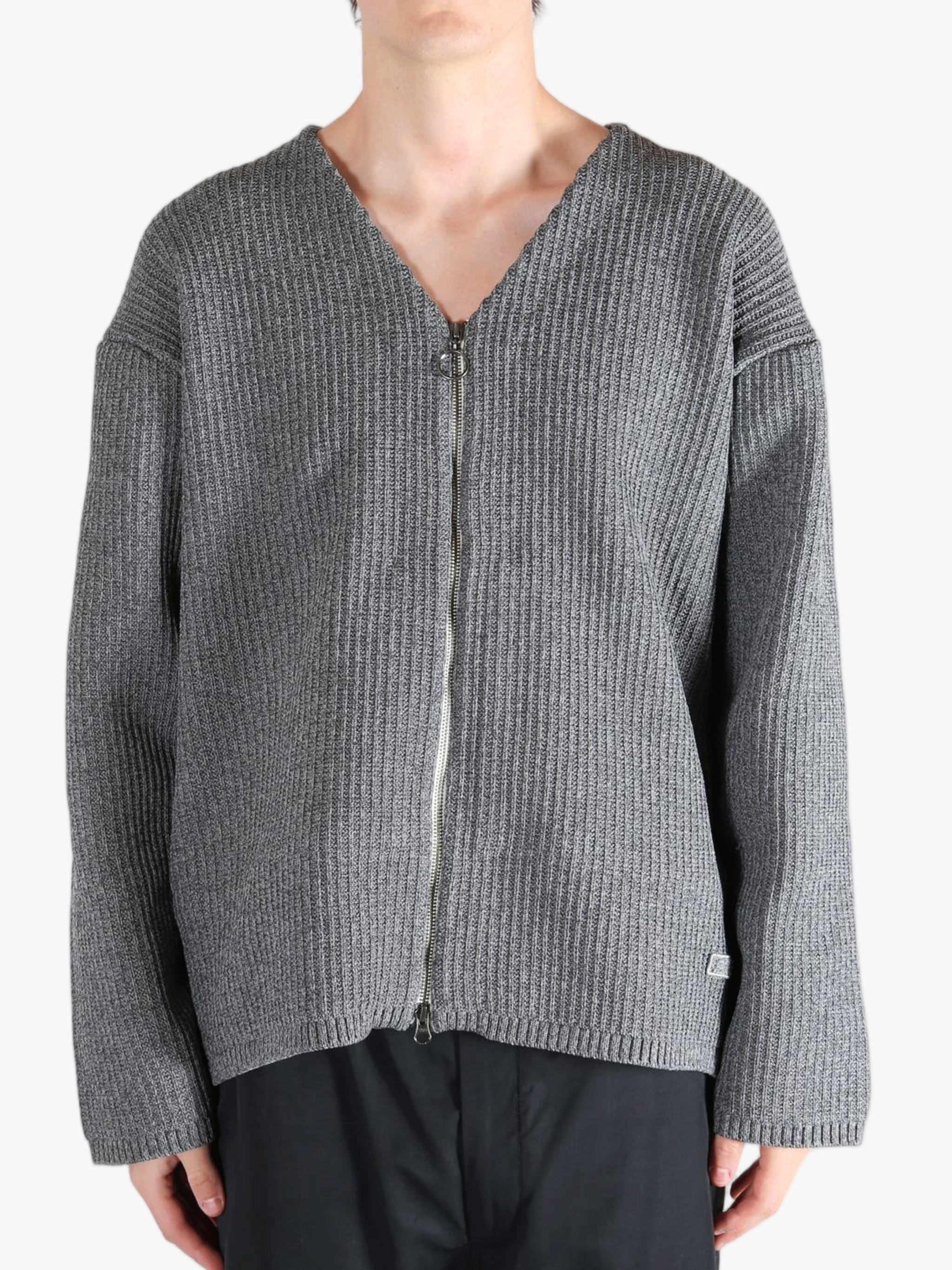 Grey sweater worn by a person, showing the sweater fit